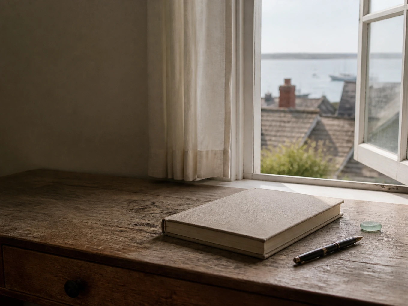 A linen guestbook beside an open Provincetown harbor window