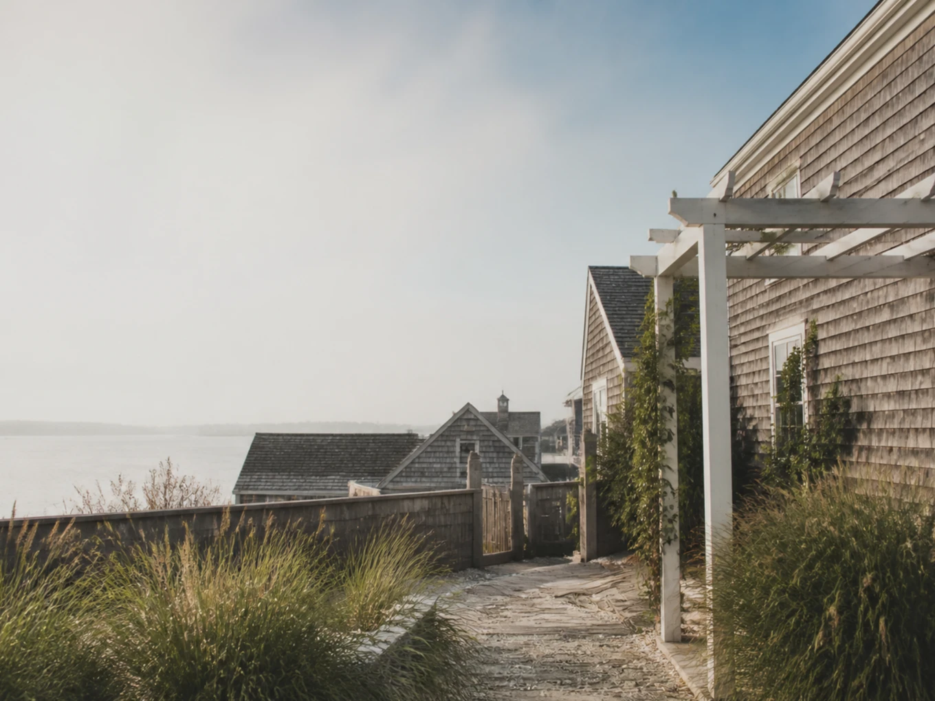 A quiet harbor-side courtyard among weathered Provincetown buildings